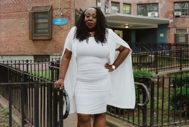 Woman posing in front of building