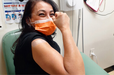 Woman nurse posing after getting vaccinated