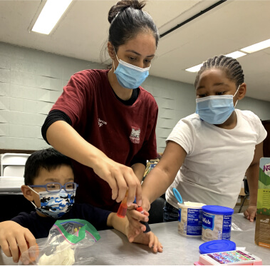 Woman with children in classroom setting