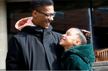 Man and daughter smiling