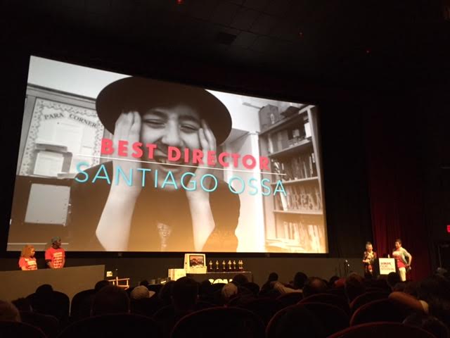 Screen proclaiming 'Best Director Santiago Ossa'